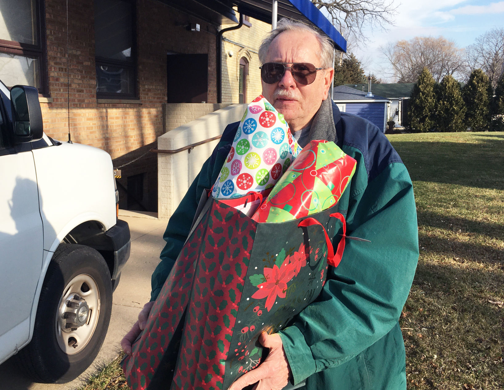 Tom Busse carries gift bags loaded onto trucks for delivery to veterans home